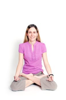 Young woman sitting in lotus seat practicing yoga 