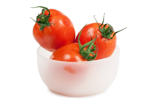 Three juicy tomatoes in the plate isolated on the white