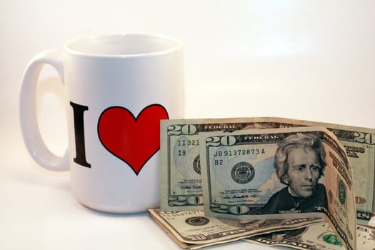 White I love mug and US money against a white background. Business, economy, market, trade and financial investment.