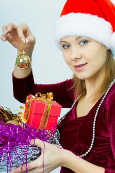smiling girl in Santa hat with Christmas decorations
