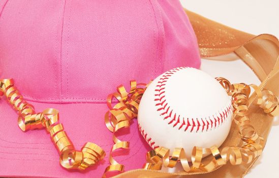 Pink baseball cap, baseball, and gold ribbons reflect  involvement of women in fitness and sports