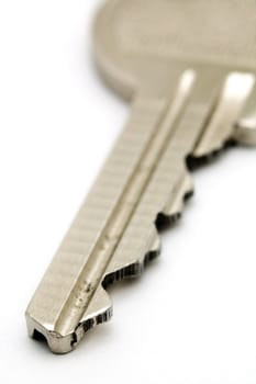 detail photo of steel key isolated on white background, distance blur