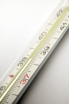 clinical thermometer detail, hight temperature, grey background