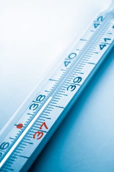 colored clinical thermometer detail, hight temperature, cyan background