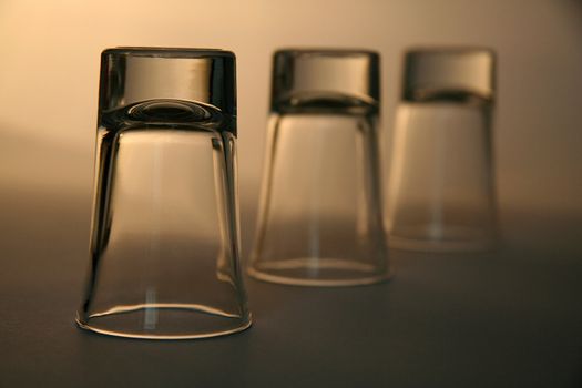 three empty alcohol glasses, distance blur, brown background