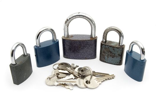 five locks and several keys isolated on white background