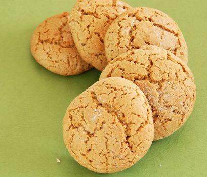 five fresh appetizing oatmeal cookies over green background