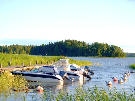 Boats at bay, at the pier, at summer, blue sky and water