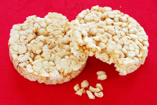 two round rice cakes over red background