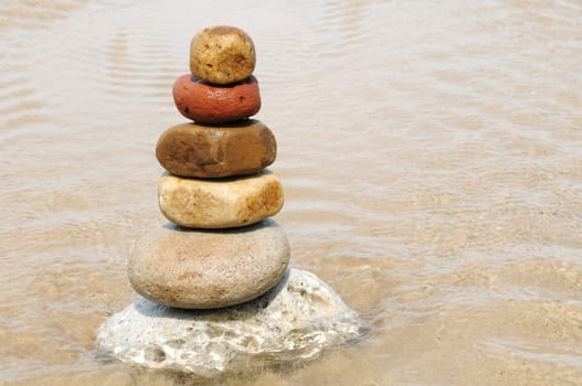 Stacking of pebbles on the seashore.