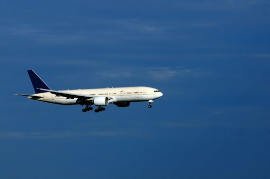 An aeroplane with landing gears switched on and ready to land
