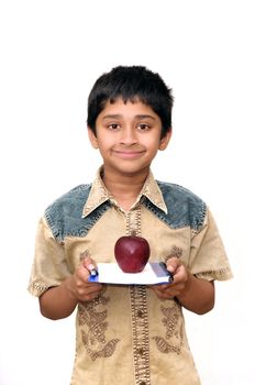 An handsome Indian kid holding apple and a book