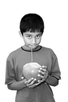   An handsome Indian kid drinking coconut water to cool off