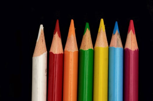 Colored pencils isolated on a black background