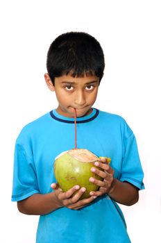   An handsome Indian kid drinking coconut water to cool off
