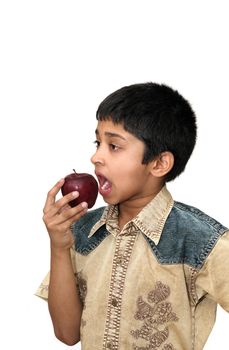 An handsome Indian kid eating apple a day