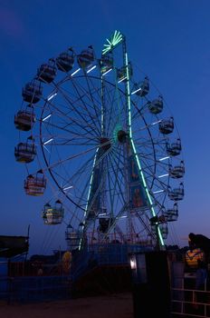 A giant ferris wheel during a tropical sunset