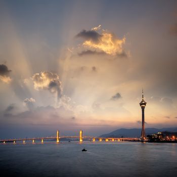 Cityscape of Macau with bridge and tower under sunset in Macao, Asia.