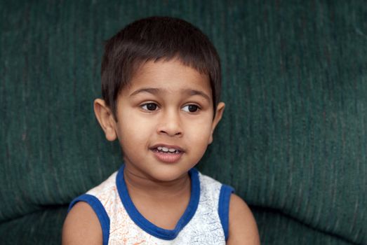 handsome indian kid smiling in front of the camera