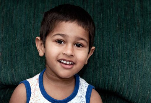 An handsome Indian kid smirking for you