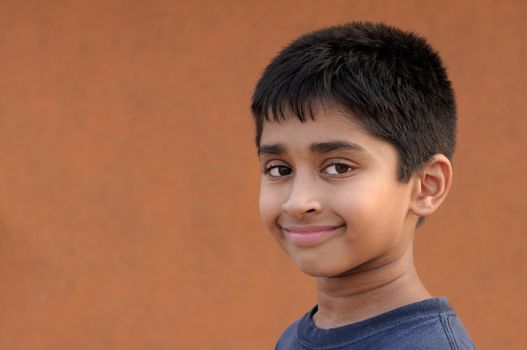 Handsome Indian kid smiling in front of the camera