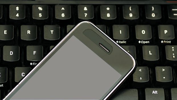 Cell Phone, keyboard a concept of modern business