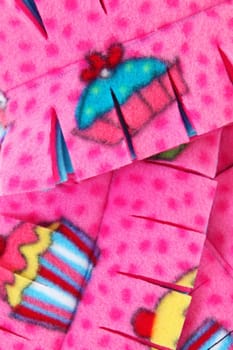 Close up of pink and multi colored cupcake themed scarf.