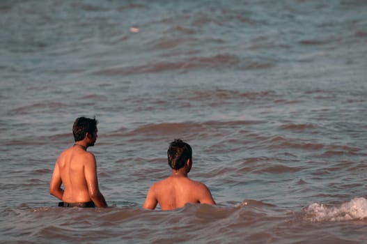 an young chap swimming in the ocean