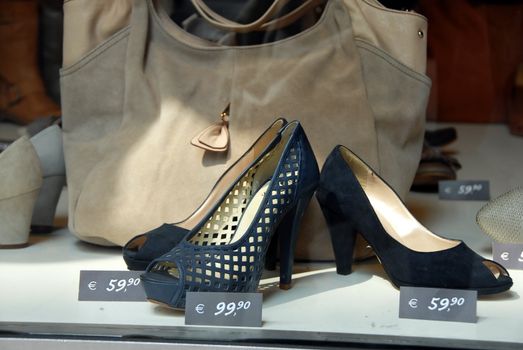 various fashionable woman's shoes in shop window