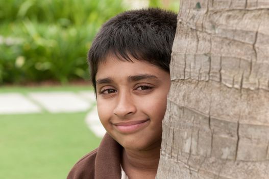 An handsome Indian kid peeping thru the trunk