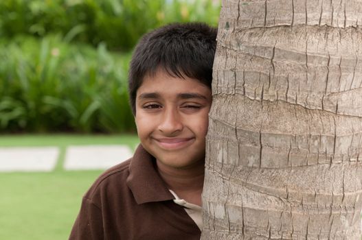 An handsome Indian kid peeping thru the trunk