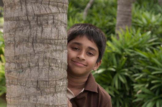 An handsome Indian kid peeping thru the trunk