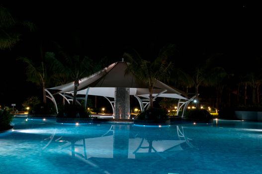 A pretty swimming pool in night at a local resort