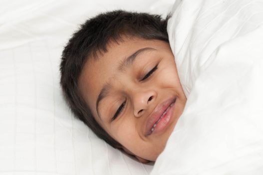 A handsome indian kid smiling for you