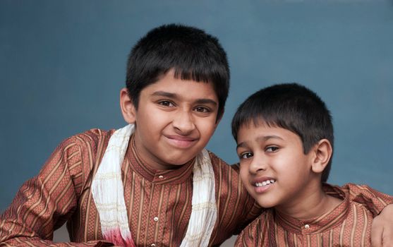 two handsome indian brothers looking happy