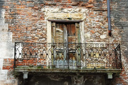 balcony of old brick building in Verona, Italy