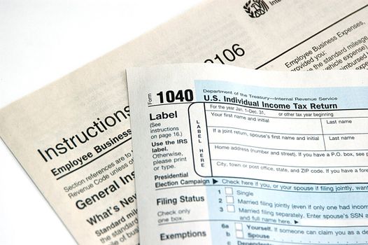 Hand signing a tax form concept of filing tax