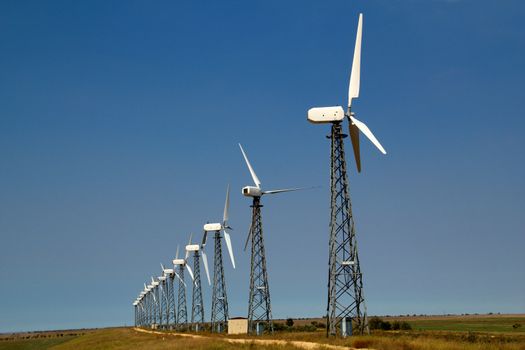 The wind generators against the blue sky