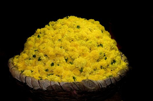 basket full of yellow flowers at a local flower market