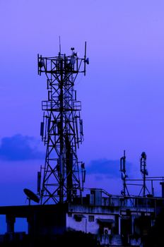 A communication tower on a moody evening