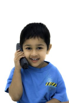 An handsome Indian kid alking happily on a phone