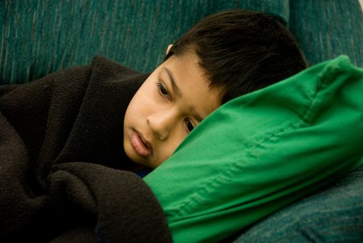 An handsome Indian kid looking very sick