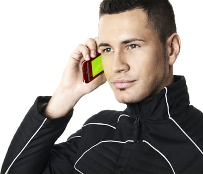 Studio shot of the young man in futuristic jacket with cell phone in right hand. Isolated on white background