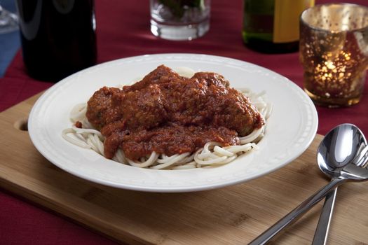 Spaghetti dinner with meatballs and tomato sauce.