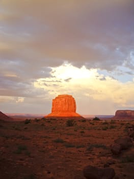 Sunset beams on rock in Monument Valley after a Summer storm