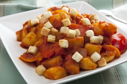 Vegetarian hungarian goulash in white bowl with croutons.