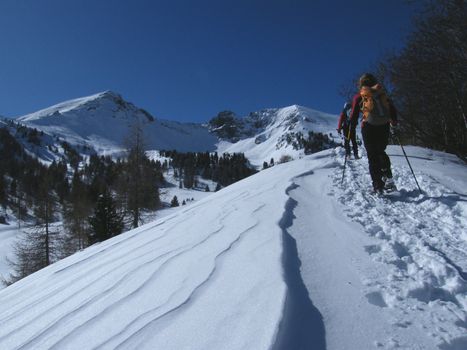 people walking in the snow, on mountains