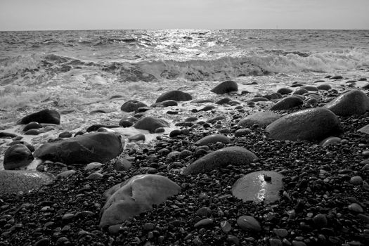 Black and white picture of the rolling stones and water at Moelen