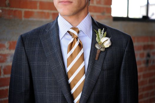 Image of a Gray Plaid suit with tan stripes and boutonniere