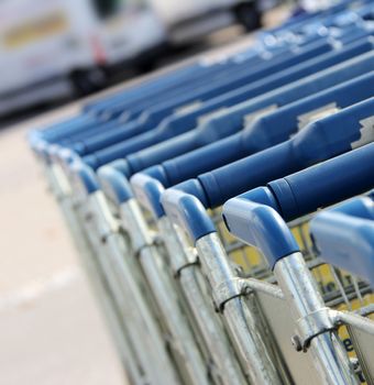 many shopping carts in a row are waiting for using
